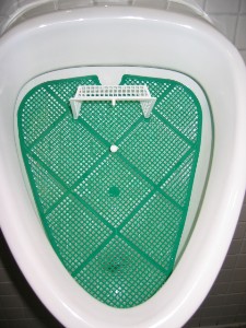 Another perk to being a guy.... Urinal soccer!  You just, uh, hit the little white ball with, um, you know...